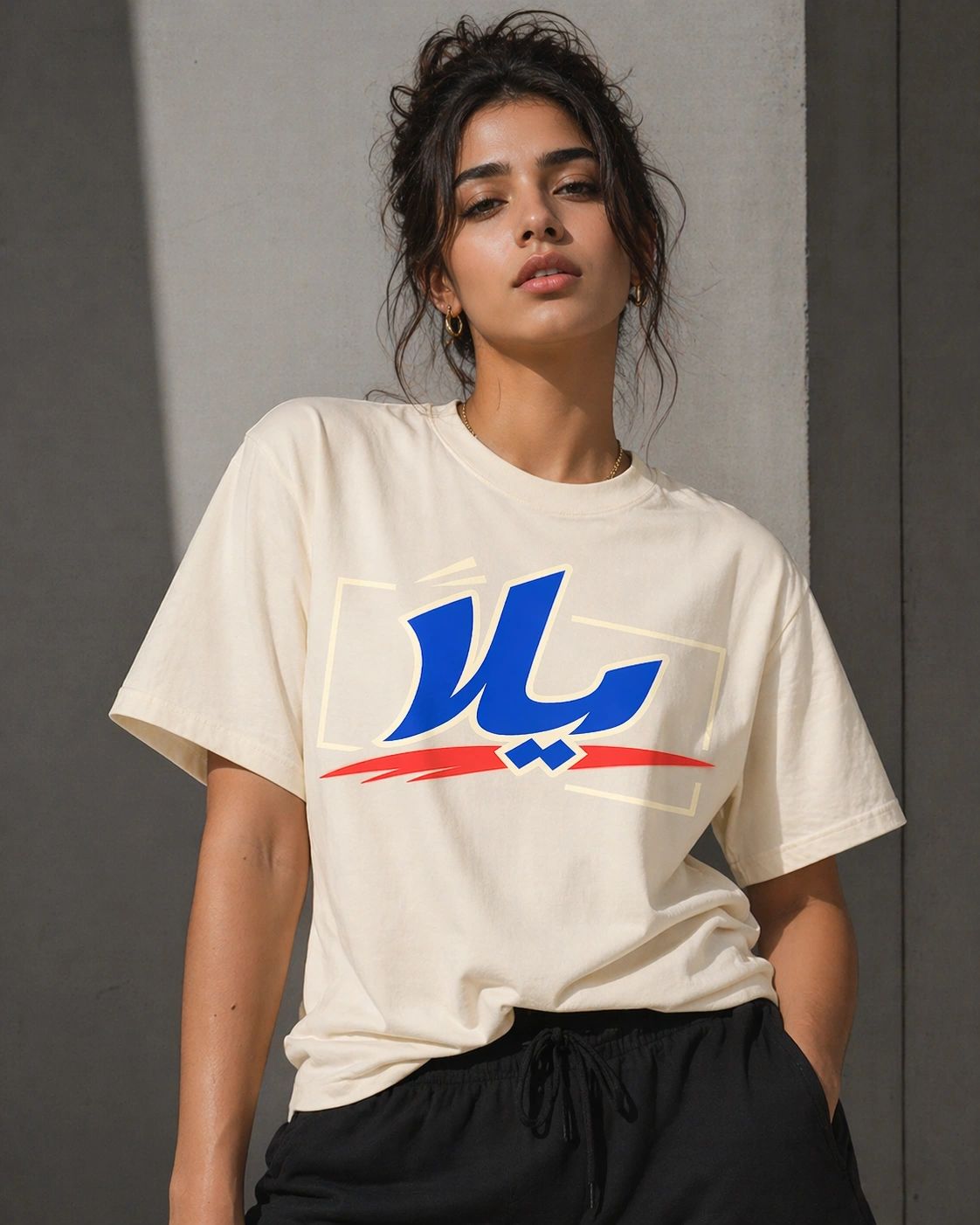 Yalla Retro Graphic Tee in blue with vibrant red Arabic typography.